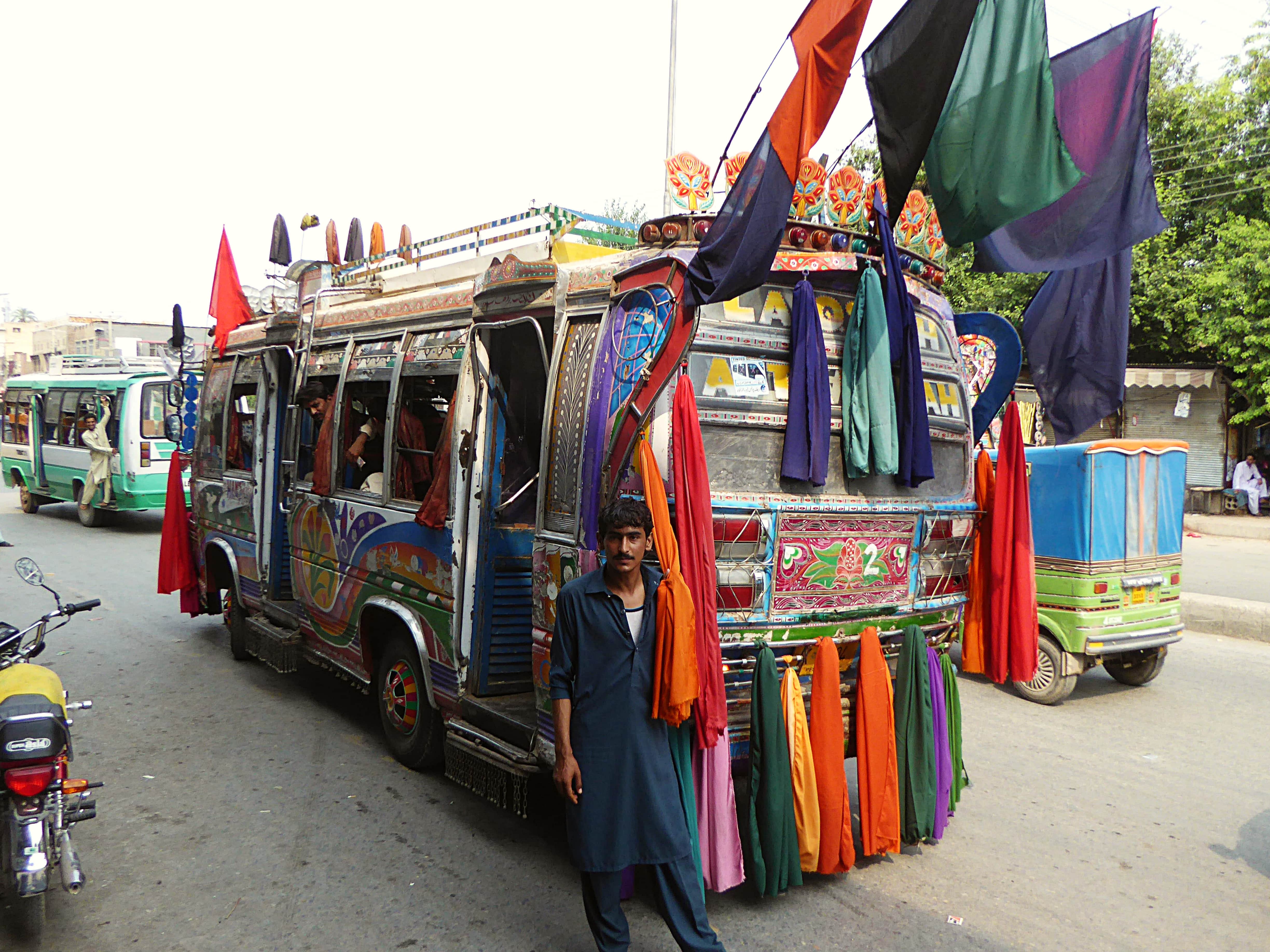 Bus in Peshwar with coloured flags.